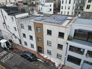 Render cleaning in progress on a building in Brighton and Hove with visible foam and cleaning equipment